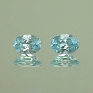 IceBlueZircon oval pair 6.4x4.6mm 1.85cts H zn7093 scaled 1