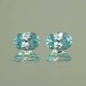 IceBlueZircon oval pair 7.6x5.5mm 3.10cts H zn7096 scaled 1